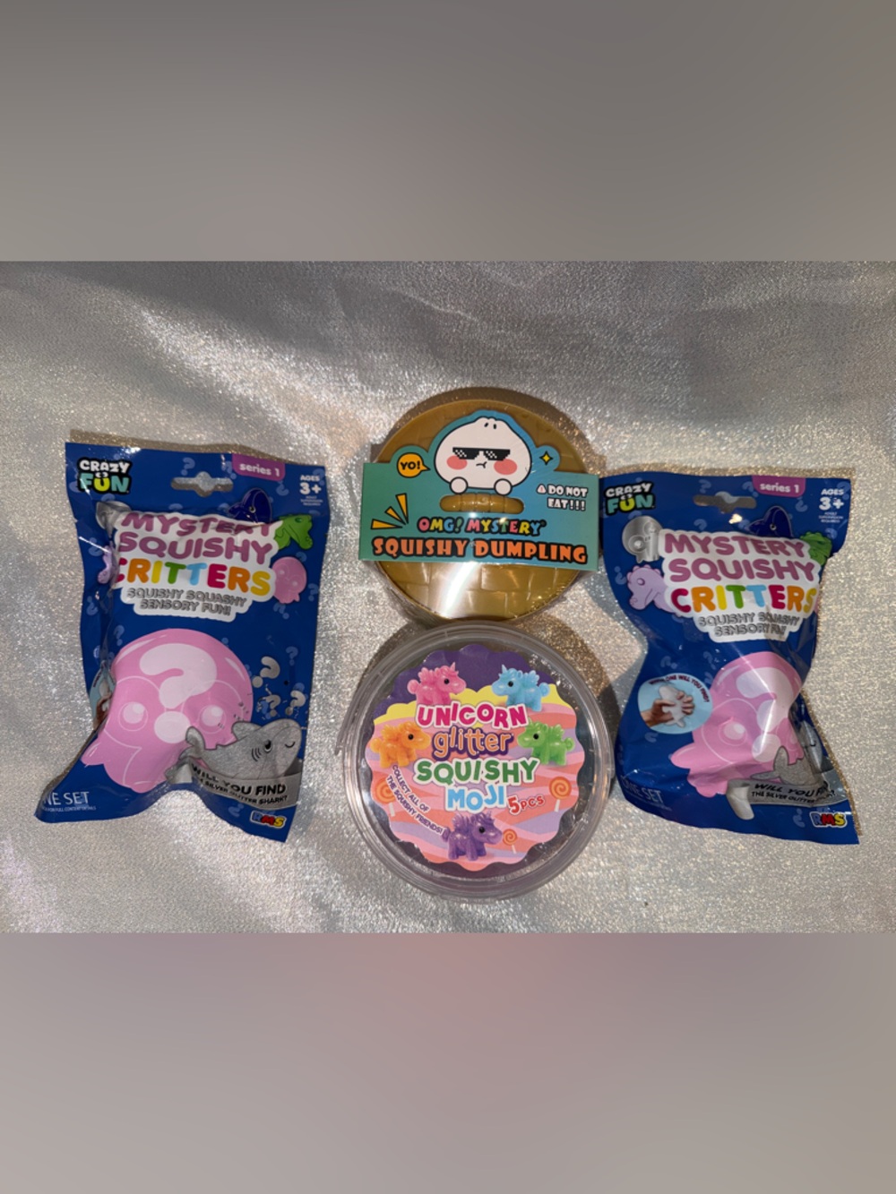 1 Unicorn Squishy (5 ct),1 OMG Mystery Dumpling & 2 Squishy Critters Mystery Bag